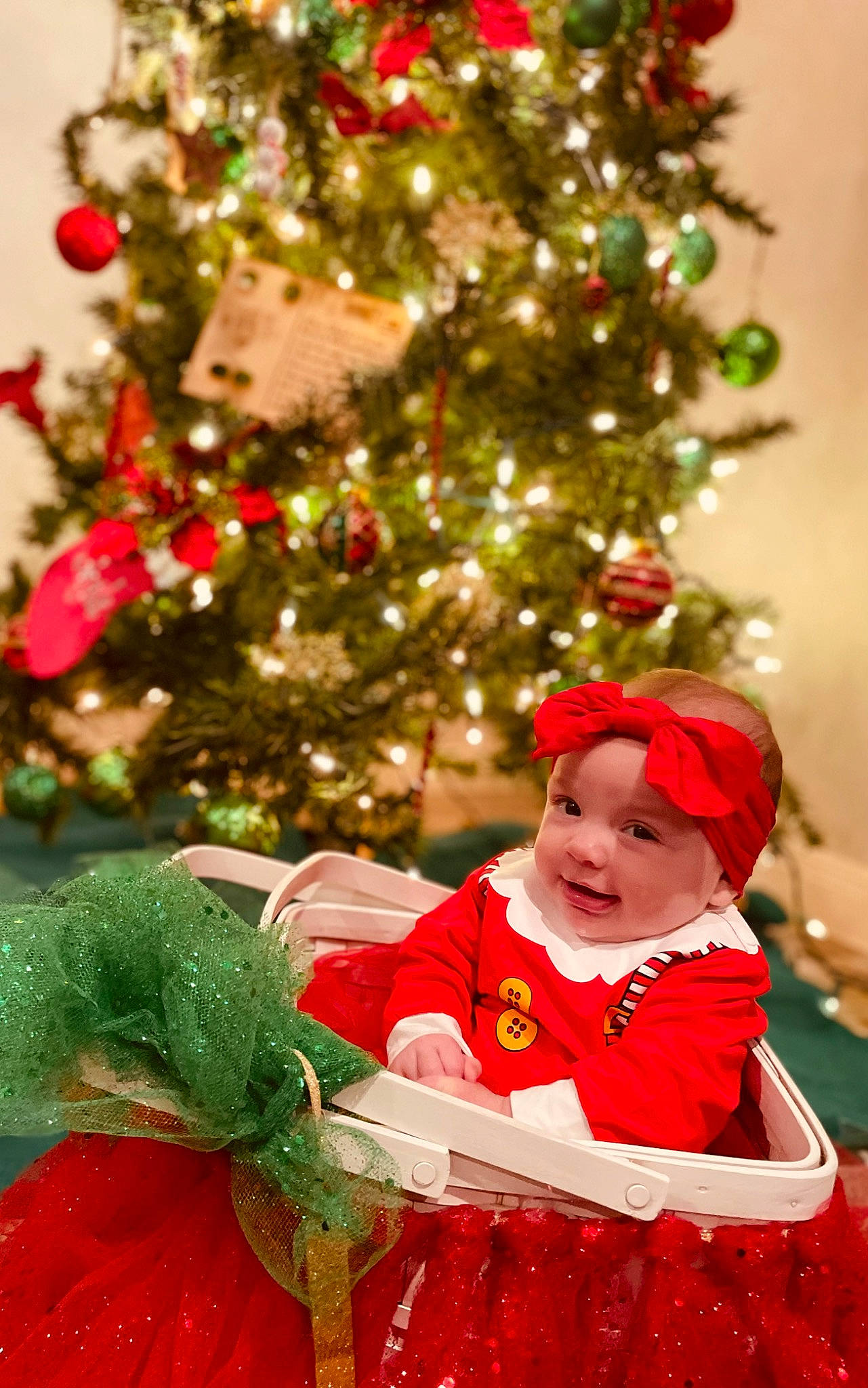 Justyce is registered to the contest to win money with this photo: baby_toddler_clothing, christmas, christmas_decoration, christmas_eve, christmas_ornament, christmas_tree, event, evergreen, happy, headwear, holiday, holiday_ornament, ornament, person, plant, red, sleeve, smile, toddler, tree
