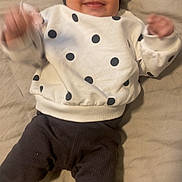 Sekaiyah is registered to the contest to win money with this photo: baby, infant, smile, polka_dot, sweater, headband, lying_down, socks, happy, cute, child, person, apparel, indoor, face, hand, feet, clothing, portrait, warm