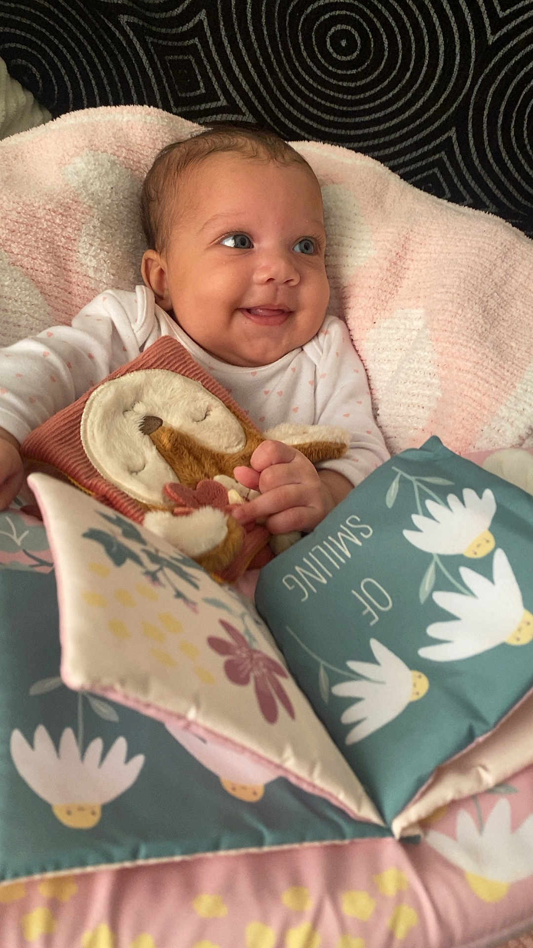 Sekaiyah joined the competition — help win amazing prizes! baby, smiling, blanket, plush_toy, fabric_book, flower_pattern, pink, blue, soft_toys, child, happy, infant, cute, playtime, indoors, portrait, hands, clothing, person, cozy