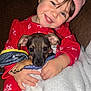 Dulce Sofia is registered to the contest to win money with this photo: blanket, child, couch, cozy, cute, face, fur, hands, happy, indoor, pet, pink_hat, portrait, puppy, red_pajamas, smiling, snuggle, warm, winter_clothing, young