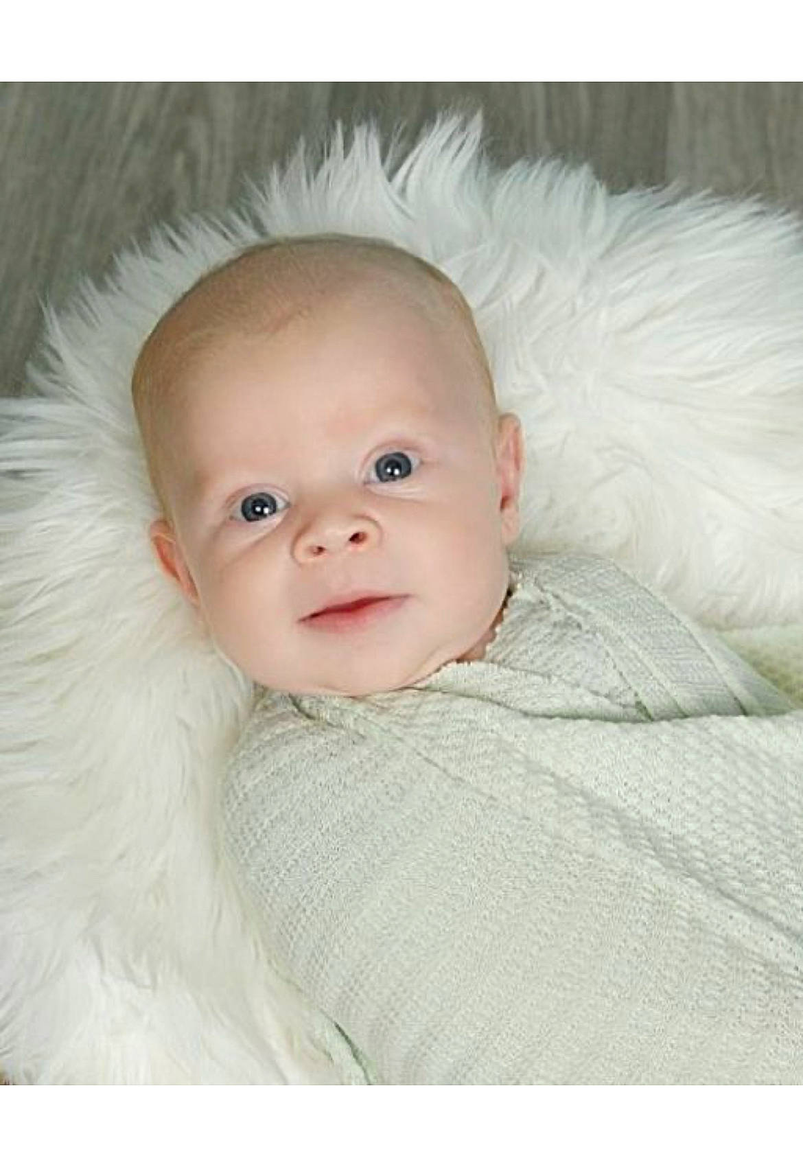 Chance is registered to the contest to win money with this photo: baby, baby_toddler_clothing, cheek, child, comfort, eyelash, fashion_accessory, flash_photography, fur, happy, iris, linens, lip, nose, person, portrait, portrait_photography, sitting, sleeve, smile