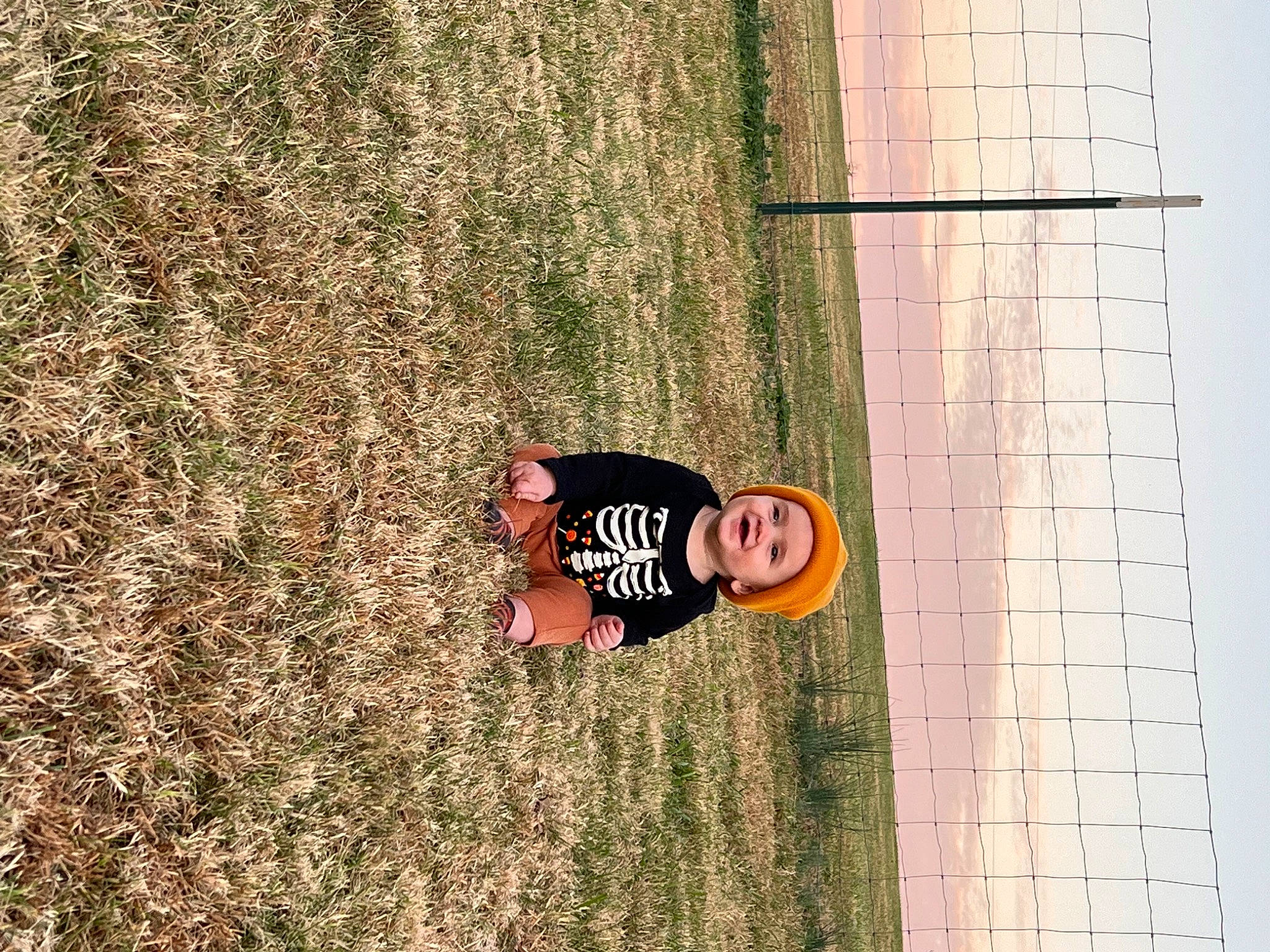 Ozzy is registered to the contest to win money with this photo: brickwork, font, fun, grass, happy, hat, headwear, leisure, mesh, net, people_in_nature, person, plant, player, shadow, soil, sports, t_shirt, trunk, wall