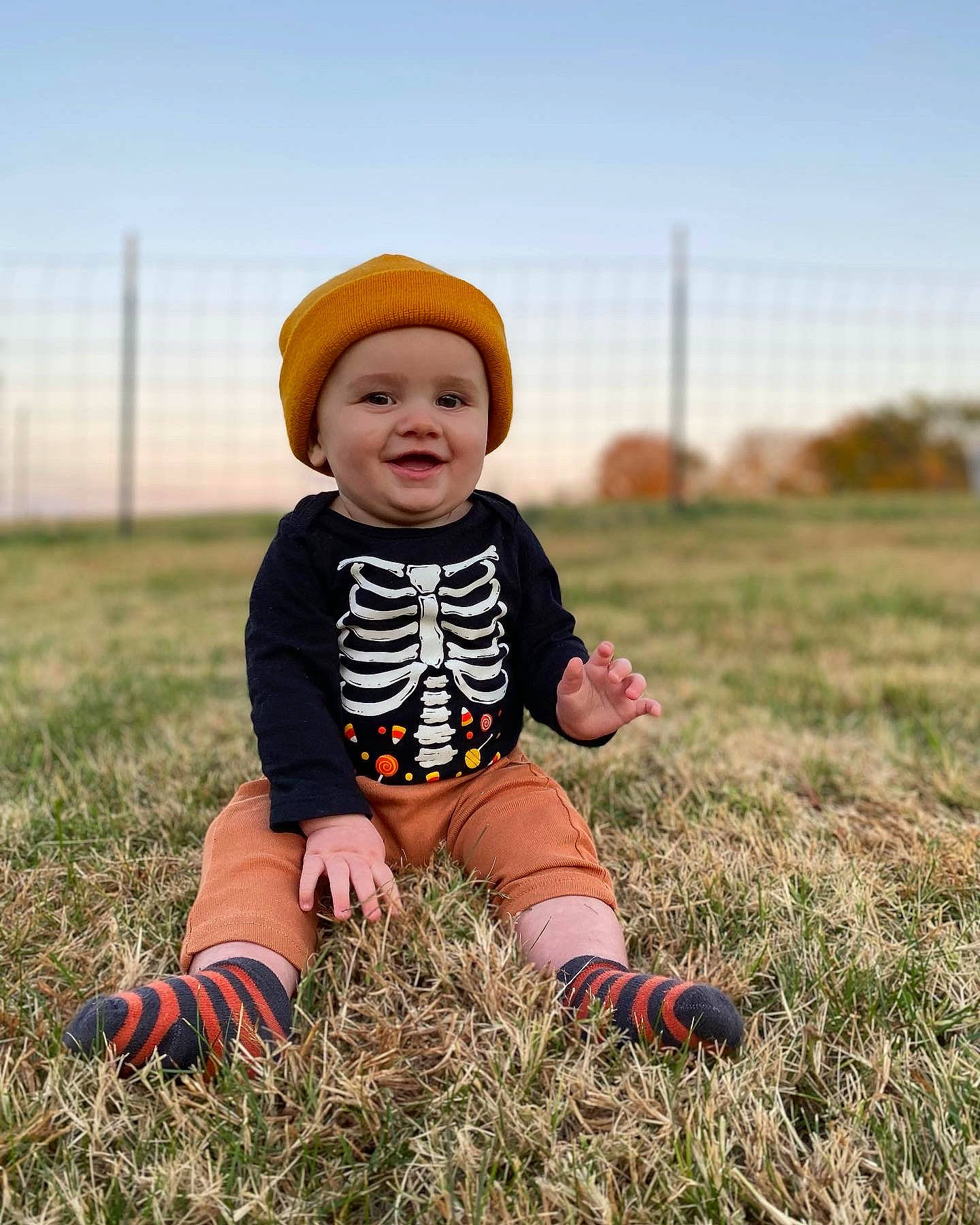 Ozzy joined the competition — help win amazing prizes! baby, baby_toddler_clothing, ball, cap, child, eye, flash_photography, fun, grass, grassland, happy, headwear, joy, landscape, people, people_in_nature, person, plant, prairie, sitting