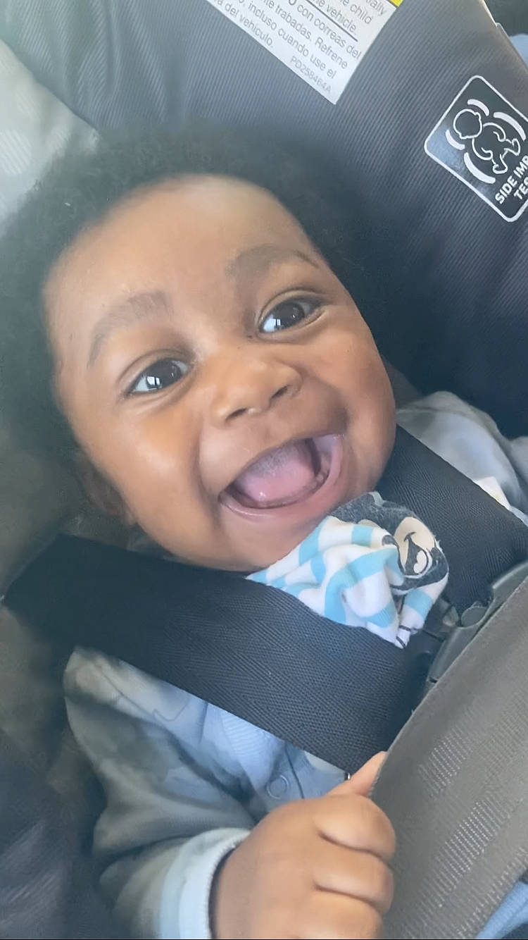 Jaydan is registered to the contest to win money with this photo: baby, baby_laughing, car_seat, cheek, comfort, electric_blue, eye, fashion_accessory, fun, gesture, happy, hat, helmet, iris, lip, nose, person, selfie, smile, toddler