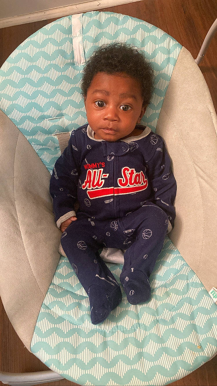 Jaydan joined the competition — help win amazing prizes! baby, baby_products, baby_safety, baby_toddler_clothing, carmine, chair, cheek, child, comfort, fashion_accessory, flooring, fun, head, linens, lip, long_sleeved_t_shirt, person, sitting, sleeve, t_shirt