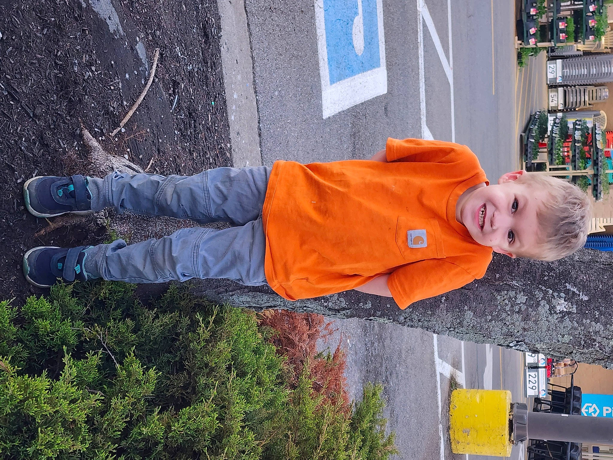 Elliott is registered to the contest to win money with this photo: electric_blue, fun, grass, hat, joy, leisure, orange, person, product, red, shelf, smile, standing, toddler, tree, walking_shoe