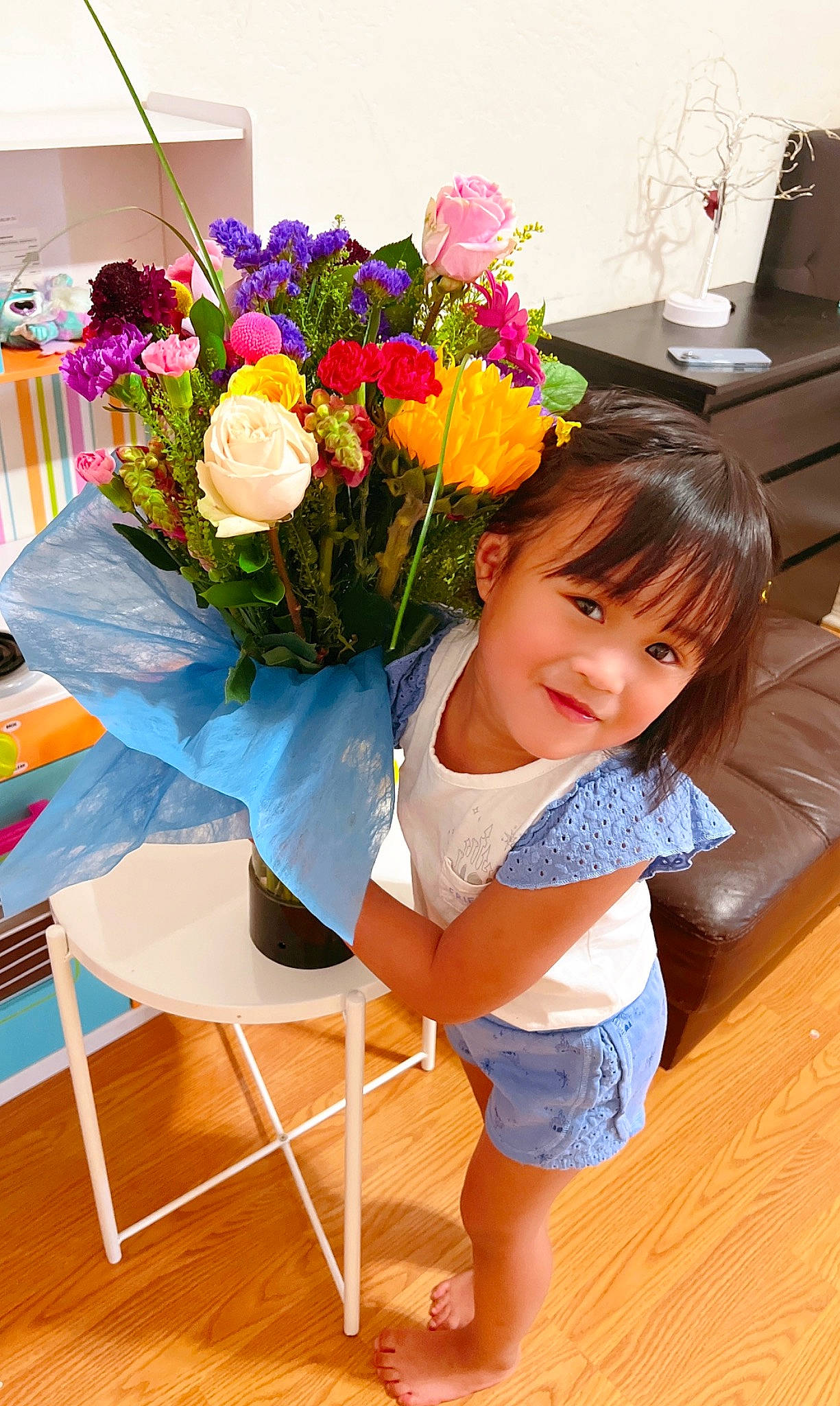 Celine joined the competition — help win amazing prizes! baby_toddler_clothing, bouquet, chair, cut_flowers, flooring, flower, flower_arranging, flowerpot, happy, human_leg, joy, leisure, orange, person, petal, plant, rose, shorts, smile, table