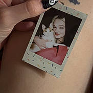 Stormy joined the competition — help win amazing prizes! background, black_nail_polish, cat, closeup, colorful_frame, cuddle, feline, hand, happy, holding, instant_photo, nail_art, person, photograph, portrait, ring, skin, smile, sprinkles, tattoo