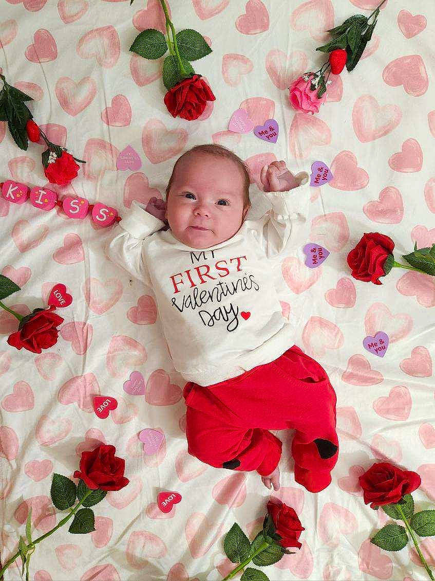 Kal-el is registered to the contest to win money with this photo: baby, baby_toddler_clothing, child, face, flower, font, green, happy, linens, magenta, pattern, person, petal, pink, plant, red, sleeve, t_shirt, textile, toddler