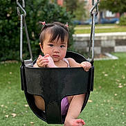 Juliette joined the competition — help win amazing prizes! toddler, child, swing, playground, outdoor, grass, greenery, park, baby, cute, hair_ties, black_swing, foot, holding, expression, nature, urban_background, daylight, person, recreation
