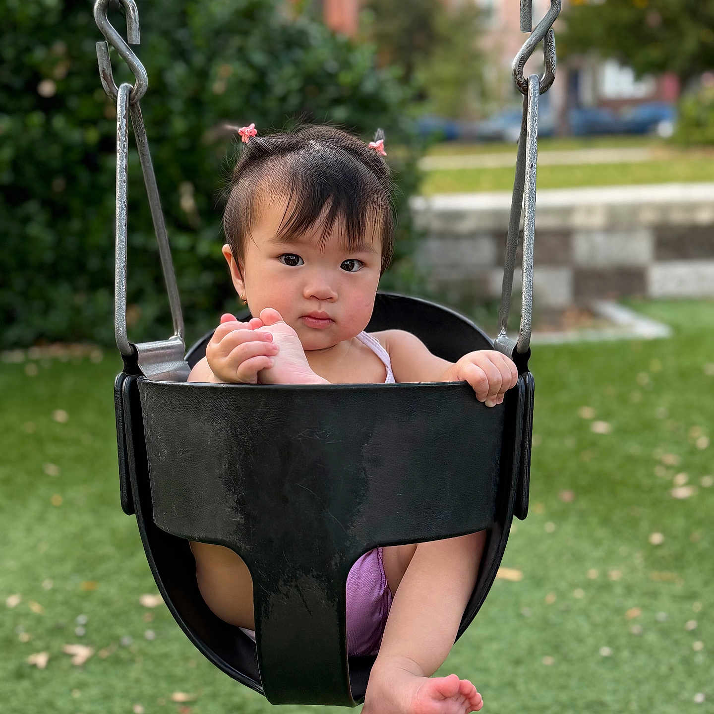 Juliette joined the competition — help win amazing prizes! baby, black_swing, child, cute, daylight, expression, foot, grass, greenery, hair_ties, holding, nature, outdoor, park, person, playground, recreation, swing, toddler, urban_background