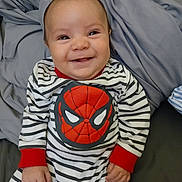 Oliver joined the competition — help win amazing prizes! baby, smiling, striped_clothing, onesie, spiderman, infant, child, cute, happy, indoors, blanket, soft, wrinkled, comfort, portrait, person, chubby_cheeks, casual, seated, young