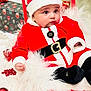 Shivin joined the competition — help win amazing prizes! baby, black_belt, celebration, child, christmas_ornaments, cute, decoration, festive, gift_boxes, holiday, holiday_decorations, indoor, infant, portrait, red_clothing, red_hat, santa_claus_costume, sled, smiling, white_fur