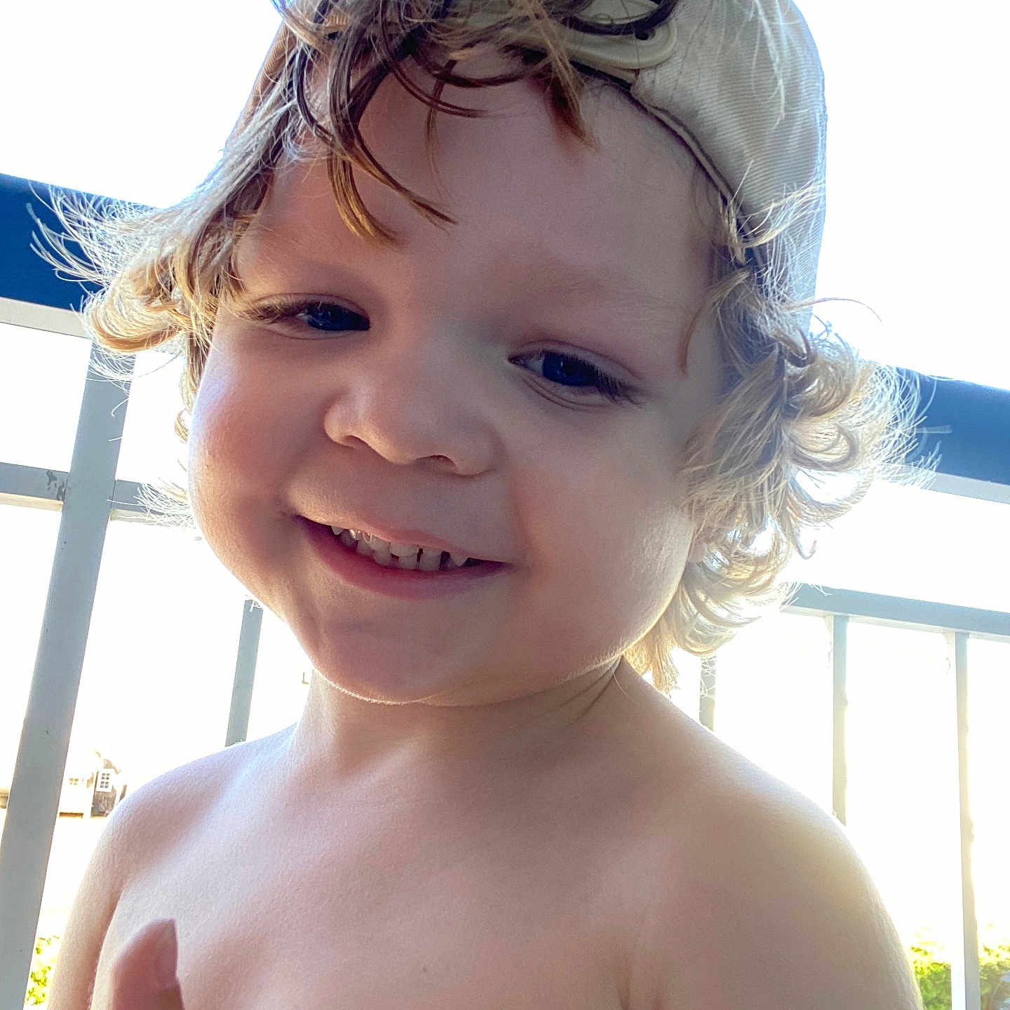 Liam is registered to the contest to win money with this photo: baby, baseballcap, bodypart, cap, clothing, cream, dessert, face, finger, food, hand, happy, hat, head, person, photography, portrait, smile, summer, swimwear