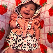 Violet joined the competition — help win amazing prizes! baby, infant, child, smiling, happy, portrait, hood, dress, frills, cow_print, strawberry_blanket, pink, coral, lying_down, indoor, close_up, face, eyes, baby_clothing, cute