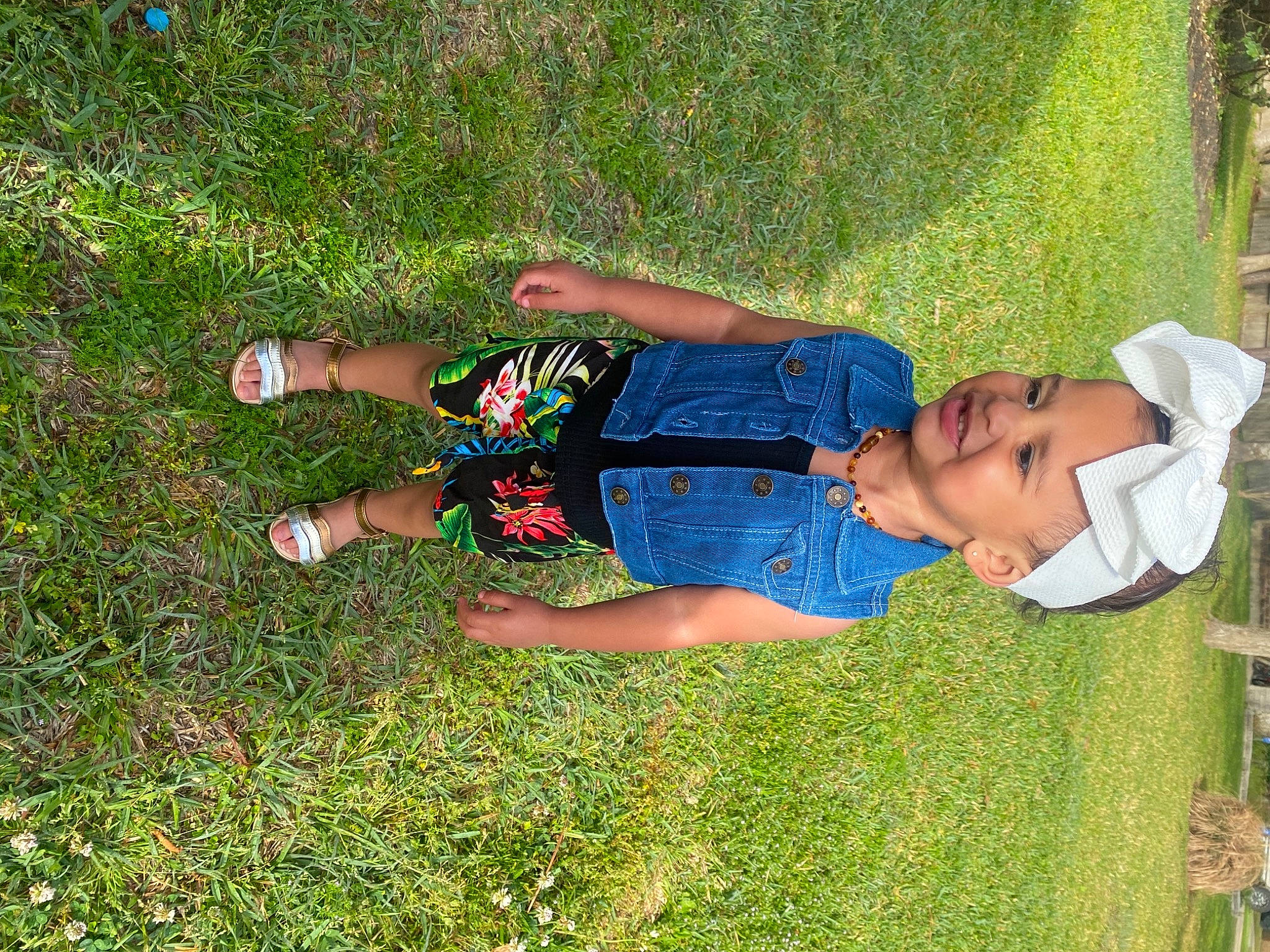 Gianna is registered to the contest to win money with this photo: baby_toddler_clothing, child, electric_blue, fun, grass, grass_family, grassland, groundcover, happy, hat, human_leg, joy, lawn, leg, leisure, meadow, people_in_nature, person, plant, recreation