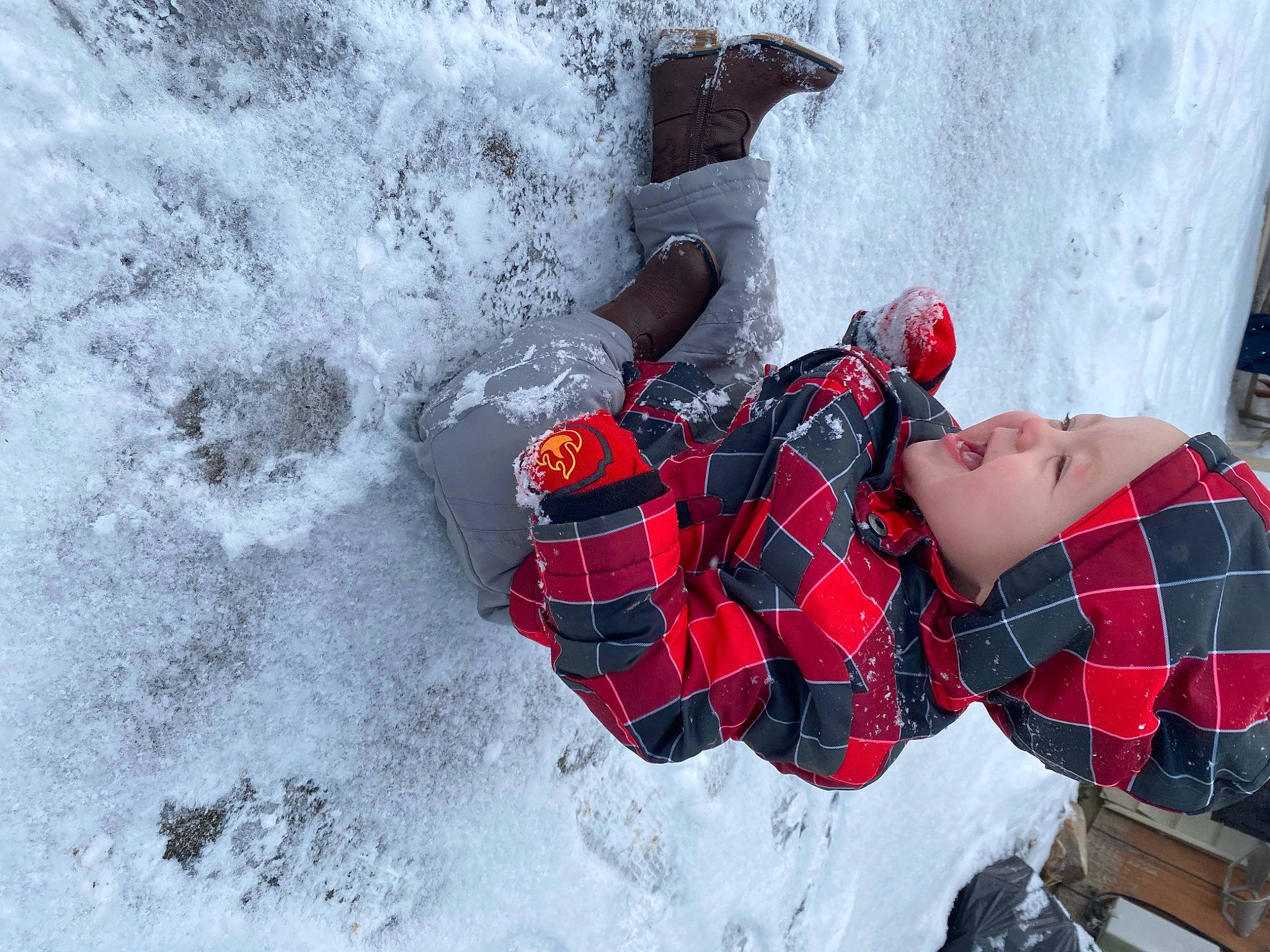 Charlie is registered to the contest to win money with this photo: carmine, event, fictional_character, freezing, frost, fun, geological_phenomenon, glove, hat, headwear, human_leg, leisure, pattern, person, personal_protective_equipment, plaid, recreation, snow, tartan, thigh