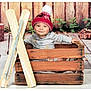 Lorenzo a rejoint le concours — aidez-le/la à gagner de superbes lots ! baby, child, smiling, hat, pom_pom, wooden_crate, skis, vintage, rustic, wooden_fence, greenery, winter, indoor, portrait, cute, happy, clothing, floor, background, decor