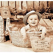 Lorenzo participe au concours pour gagner de l'argent avec cette photo : baby, child, smiling, hat, basket, woven, cactus, burlap, sack, rustic, wooden_floor, wooden_wall, fur, decor, portrait, indoors, cute, sepia, happy, person