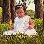 child, toddler, grass, trees, outdoor, nature, white_dress, headband, pink, sitting, curious, baby, portrait, greenery, summer, cute, young, daylight, forest, innocence