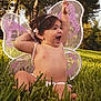 Isabella joined the competition — help win amazing prizes! toddler, child, fairy_wings, purple, grass, outdoor, happy, smiling, baby, nature, greenery, cute, playful, summer, headband, bare_chest, sitting, sunlight, joy, portrait