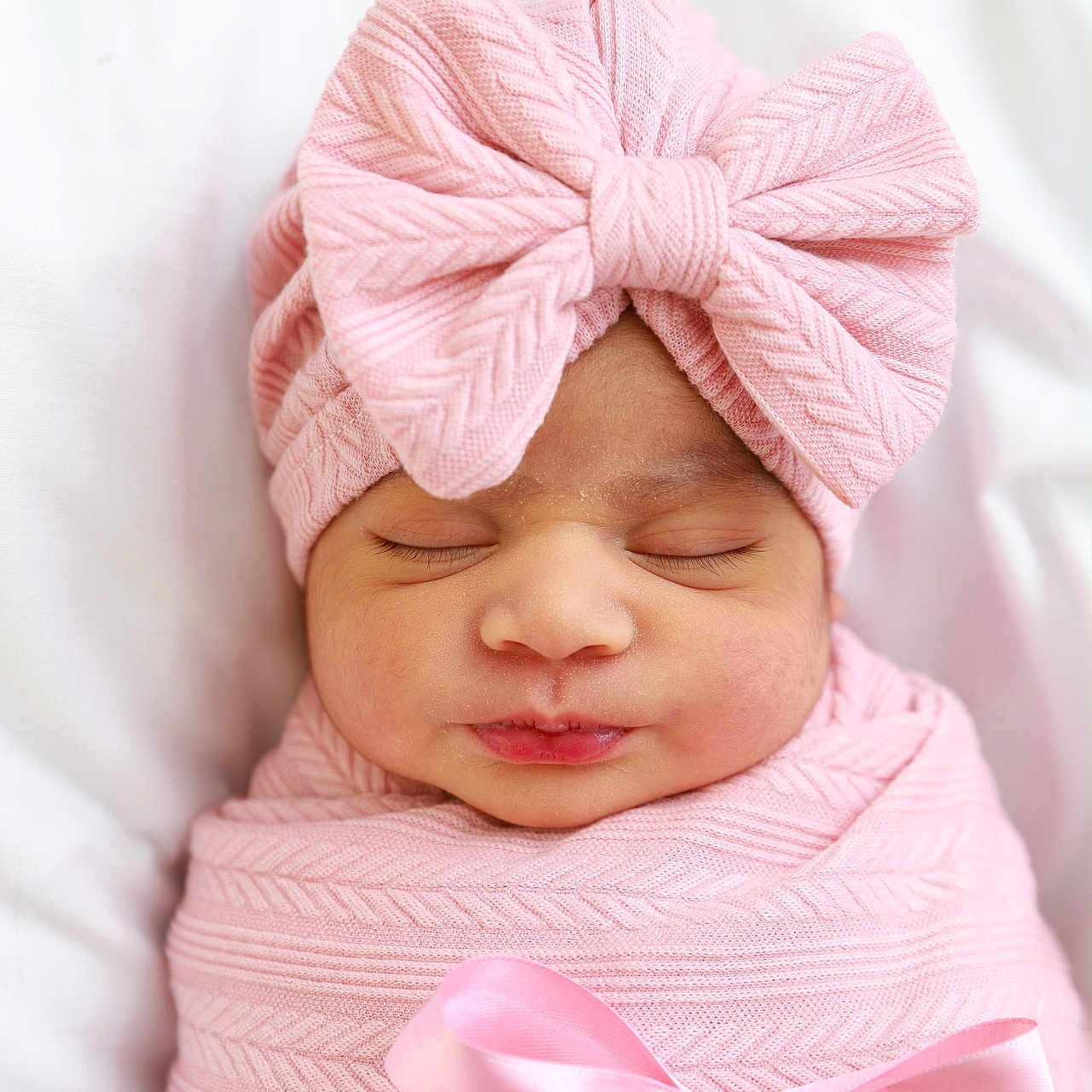 Isha is registered to the contest to win money with this photo: newborn, baby, infant, sleeping, portrait, pink, swaddled, blanket, bow, ribbon, knitwear, headband, peaceful, face, closed_eyes, indoors, bedding, soft_lighting, cute, photography