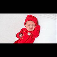 Dallas is registered to the contest to win money with this photo: newborn, baby, sleeping, red_clothing, hat, infant, cute, festive, holiday, santa_patch, white_background, peaceful, cozy, portrait, child, small_hands, relaxed, indoors, soft_texture, adorable