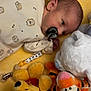 newborn, baby, pacifier, onesie, hedgehog_print, yellow_blanket, plush_toy, winnie_the_pooh, tigger, white_bear, infant, cute, sleeping_area, soft_toys, child, lying_down, cozy, indoors, personalized, baby_clip