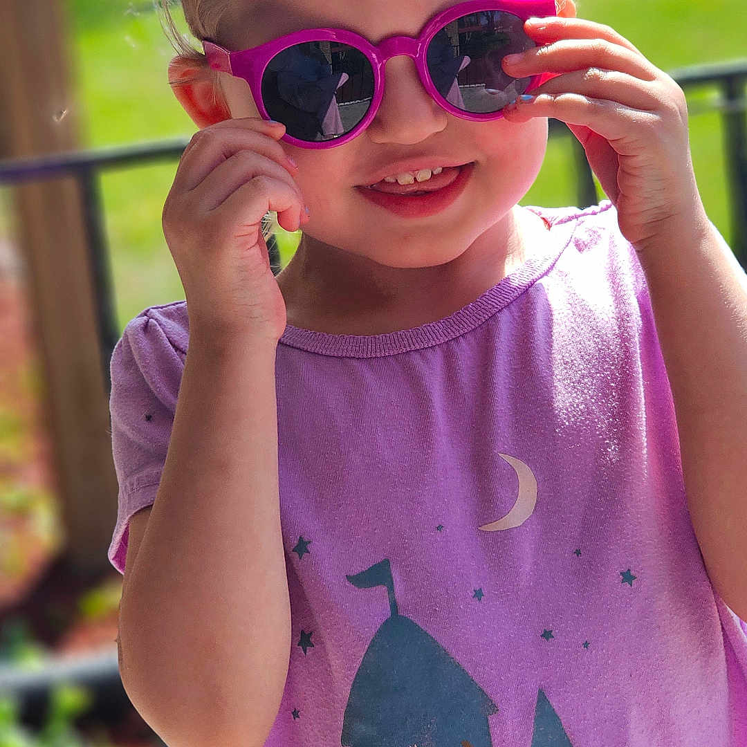 Octavia joined the competition — help win amazing prizes! accessories, applique, bodypart, child, clothing, face, female, finger, girl, glasses, hand, happy, head, person, photography, portrait, purple, smile, sunglasses, t_shirt