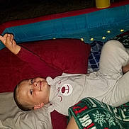 Logan joined the competition — help win amazing prizes! blanket, blue, boy, child, clothing, cozy, face, gesture, happy, head, indoor, inflatable_pool, lights, night, pillow, playful, red, relaxing, smile, white