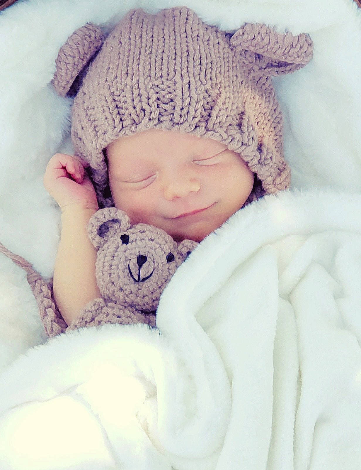 Flynn joined the competition — help win amazing prizes! baby, baby_sleeping, baby_toddler_clothing, cap, comfort, eye, fashion_accessory, fur, happy, headgear, headwear, knit_cap, linens, outerwear, pattern, person, skin, textile, toddler, white