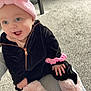 baby, child, infant, pink_headband, black_outfit, fluffy_boots, happy, smiling, carpet, indoor, person, hand, seated, cute, cozy, playful, young_child, apparel, headwear, footwear