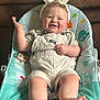Greyson joined the competition — help win amazing prizes! baby, bunny_ears, overalls, baby_chair, smiling, happy, indoor, couch, handbag, cute, child, foot, plush, person, seat, clothing, portrait, infant, cheerful, furniture