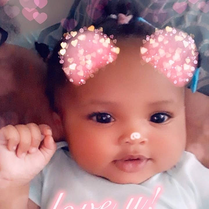 Janae is registered to the contest to win money with this photo: baby, cheek, child, eye, eyebrow, face, fashion_accessory, forehead, hair_accessory, head, headband, headgear, headpiece, lip, mouth, nose, person, pink, skin, smile