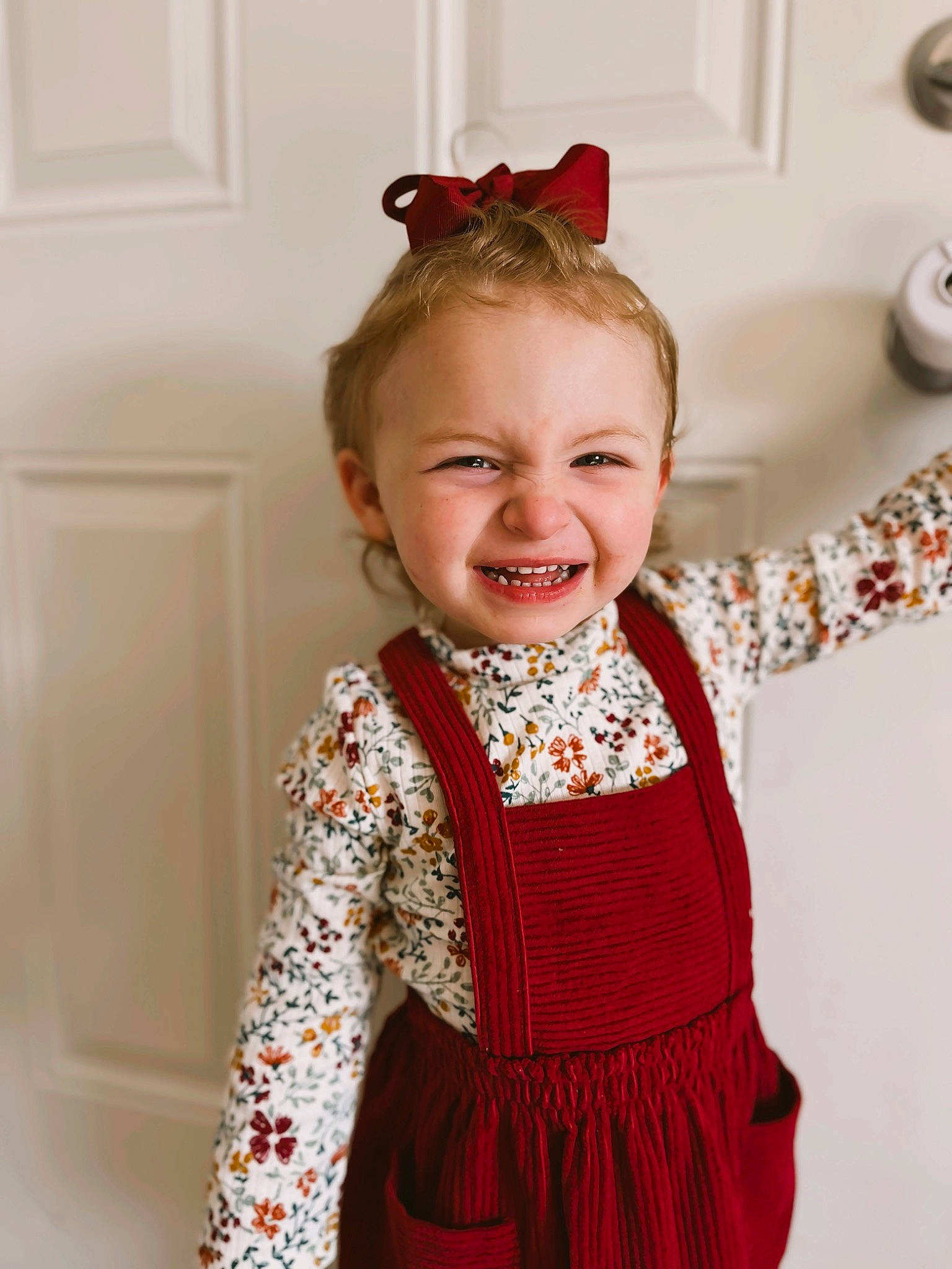 Emilee is registered to the contest to win money with this photo: baby_toddler_clothing, child, clothing, day_dress, dress, embellishment, event, face, fashion_design, happy, joy, magenta, neck, one_piece_garment, pattern, peach, person, pink, sleeve, smile