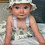 Mckenna joined the competition — help win amazing prizes! baby, child, crawling, hat, floral, dress, indoors, bed, pillow, blue, white, cute, smiling, face, person, young, skin, eyes, hands, infant