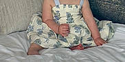 Mckenna is registered to the contest to win money with this photo: baby, child, smiling, dress, hat, bed, pillow, indoors, happy, person, portrait, cute, sitting, fabric, floral_pattern, headwear, skin, infant, blue_eyes, home