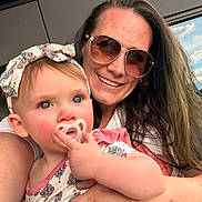 Mckenna joined the competition — help win amazing prizes! baby, woman, sunglasses, pacifier, headband, outdoor, balcony, man, glass, sky, cloud, railing, portrait, child, person, smile, hair, arm, clothing, window