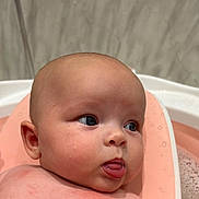Marnie joined the competition — help win amazing prizes! baby, infant, face, skin, water, bath, bathtub, pink, droplets, tongue, expression, cute, child, head, closeup, person, young, bathroom, seat, wet