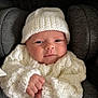 baby, infant, knitwear, hat, white, sweater, car_seat, clothing, cute, face, portrait, newborn, child, fist, cozy, warm, soft, comfort, indoors, expression