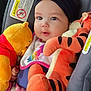 baby, child, plush_toy, winnie_the_pooh, tigger, car_seat, headband, cute, infant, toy, soft_toy, comfort, clothing, pink, orange, smiling, face, person, seat, child_safety