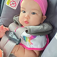 Rhianna joined the competition — help win amazing prizes! baby, infant, car_seat, pink_headband, bib, unicorn, child, seatbelt, chubby_cheeks, cute, closeup, indoors, safety, colorful, portrait, young_child, soft_lighting, baby_clothes, headwear, expression