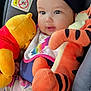 baby, child, plush_toy, winnie_the_pooh, tigger, car_seat, headwrap, infant, cute, smiling, colorful_clothing, soft_toys, indoors, closeup, happy, person, toddler, seatbelt, car, portrait