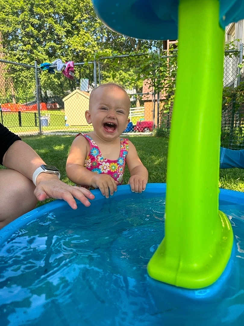 Kora joined the competition — help win amazing prizes! toddler, child, water, pool, outdoor, summer, play, happy, laughing, toy, hand, grass, fence, sunlight, sunny, person, sleeveless, garden, fun, daytime