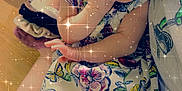 Karma is registered to the contest to win money with this photo: baby, child, infant, dress, bow, hand, face, sparkles, filter, colorful, floral, pattern, skin, person, sitting, arm, leg, indoors, softlight, cute