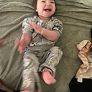 Elizabeth joined the competition — help win amazing prizes! baby, blanket, child, clapping, cozy, cute, fabric, face, feet, hands, happy, indoor, light, pajamas, person, playful, sitting, smile, soft, toddler