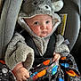 Kyler is registered to the contest to win money with this photo: baby, bonnet, cap, car, car_interior, carseat, clothing, face, hat, head, hood, hoodie, knitwear, person, photography, portrait, sweater, sweatshirt, transportation, vehicle