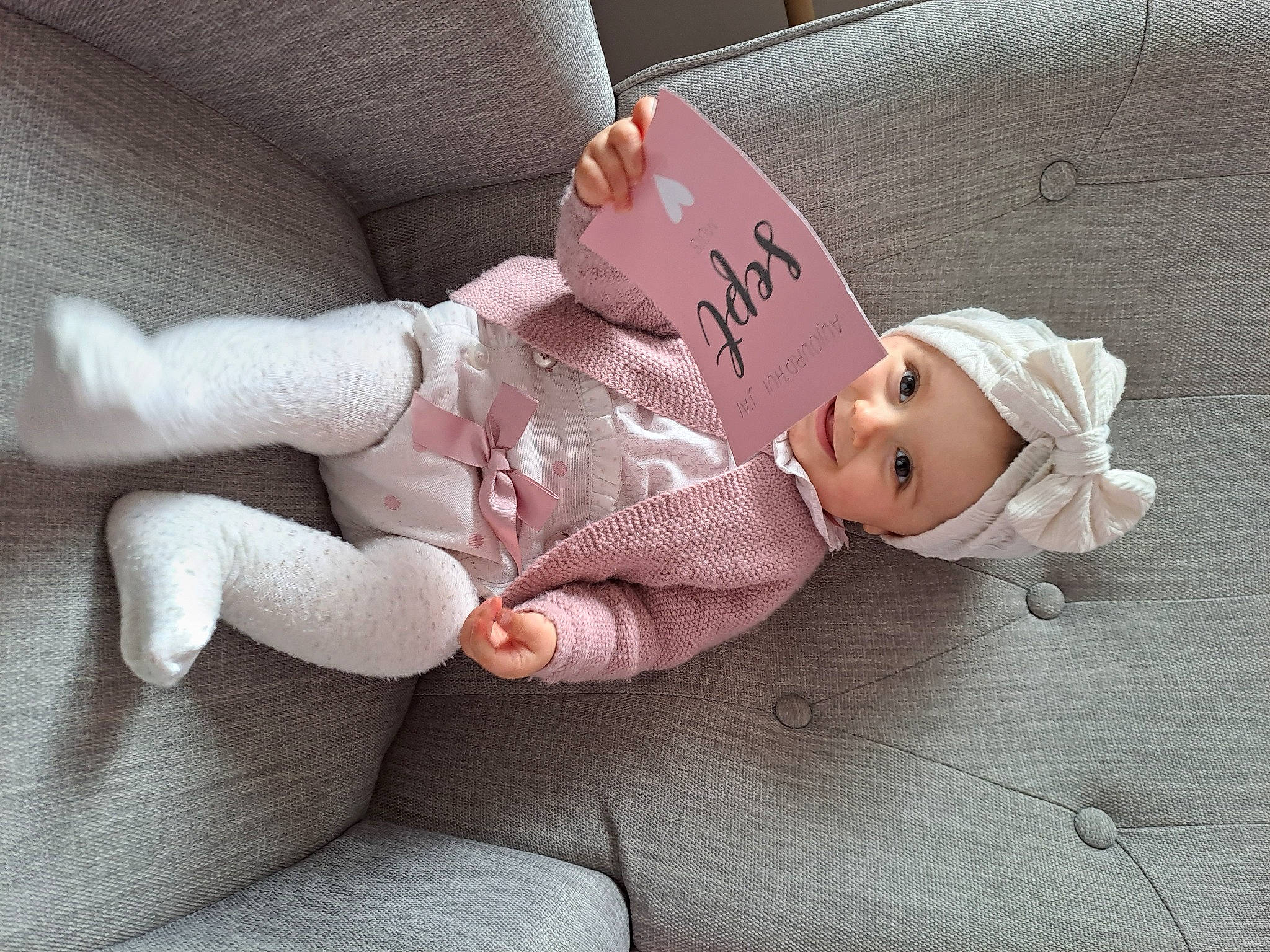 Tess participe au concours pour gagner de l'argent avec cette photo : baby, baby_products, baby_toddler_clothing, cheek, child, comfort, foot, gesture, hat, headwear, linens, nail, person, room, sitting, skin, sleeve, sock, textile, thumb