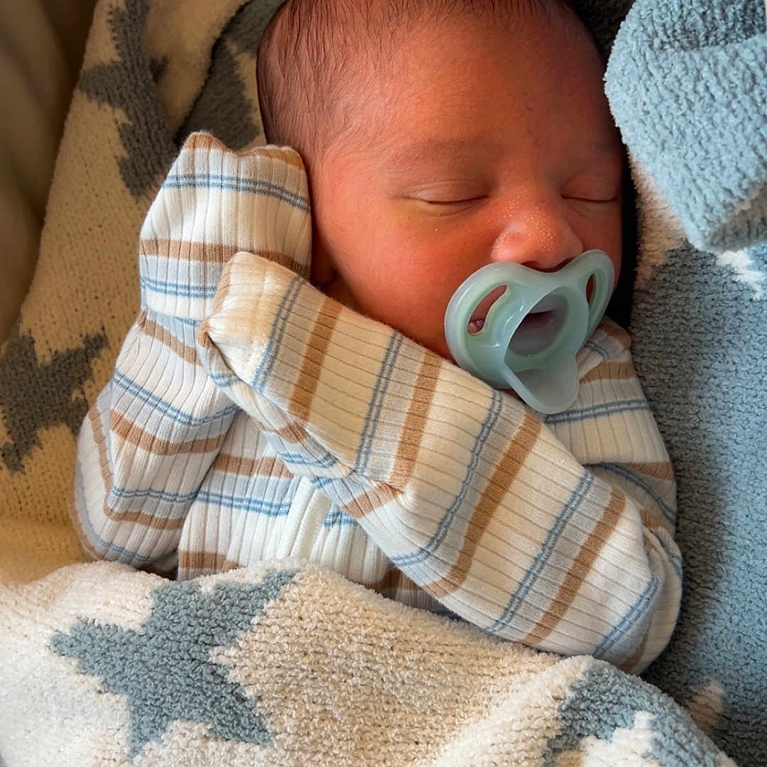 Khamil joined the competition — help win amazing prizes! baby, bed, blanket, child, closeup, cozy, cute, indoors, infant, newborn, pacifier, peaceful, portrait, resting, sleeping, soft, star_pattern, striped_clothing, warm, wrapped