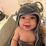 Leyah participe au concours pour gagner de l'argent avec cette photo : baby, towel, smiling, face, child, cute, indoors, portrait, happy, skin, headwear, blanket, person, infant, wrapped, soft, cozy, nursery, hand, tattoo